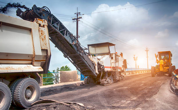 large milling machine removing an old pavement layers at full depth